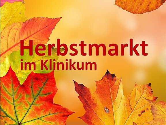 Herbstmarkt im Klinikum. Der Hintergrund zeigt eine Vielzahl von herbstlichen Blättern in verschiedenen Farben, die das Thema des Marktes unterstreichen.