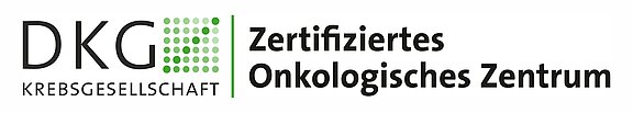 Logo der Deutschen Krebsgesellschaft (DKG) mit grünem Punktraster und der Aufschrift „Zertifiziertes Onkologisches Zentrum“; kennzeichnet die DKG-Zertifizierung.
